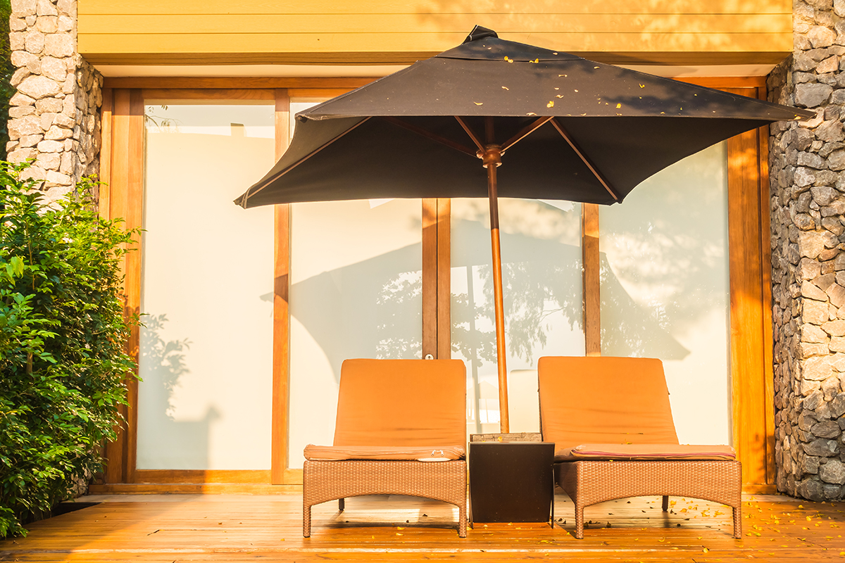 Umbrella And Chair Around Swimming Pool